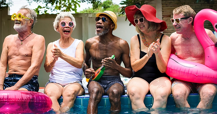 group of diverse, elderly friends, enjoying the swimming pool and the pool floats - Decatur, IL