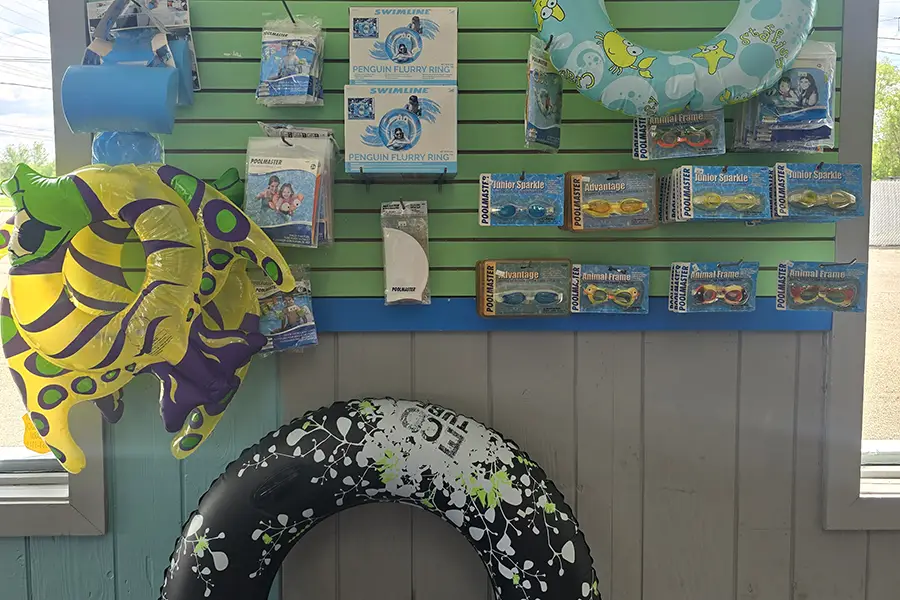 diverse group of young friends enjoying the pool on a hot summer day, with pool toys, floats, novelty towels, etc. - Decatur, IL